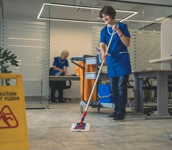 Vcare technician scrubbing a commercial floor